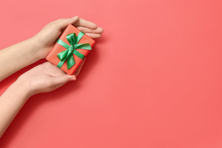 Woman with Christmas gift box on red backgroundの写真素材