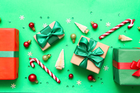 Gift boxes with Christmas decor on green backgroundの写真素材