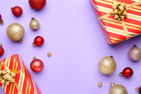 Composition with Christmas gifts and balls on lilac background