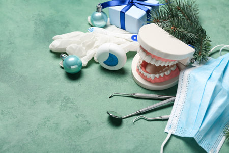 Dentist's tools with Christmas decor on green backgroundの写真素材