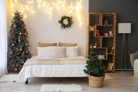 Interior of bedroom with Christmas trees and glowing lightsの写真素材