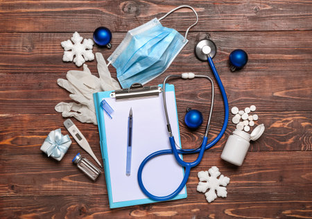 Doctor's supplies with Christmas decor on wooden backgroundの写真素材