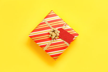 Beautiful Christmas gift on yellow background