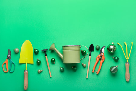 Gardening supplies with Christmas balls on green backgroundの写真素材