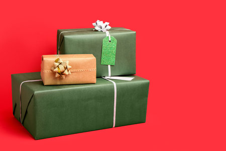 Stack of Christmas gifts on red background
