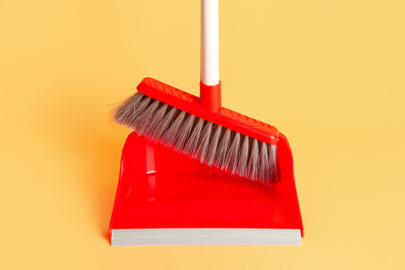 Red dustpan and broom on color background, closeupの写真素材