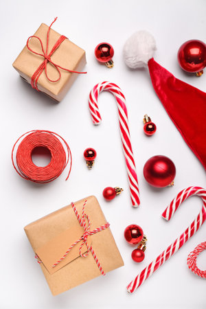 Composition with Christmas gifts, candy canes and balls on light backgroundの写真素材