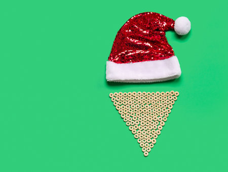 Santa hat and beard made of cereal rings on green backgroundの写真素材