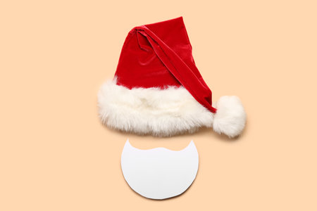 Santa hat and paper beard on color backgroundの写真素材