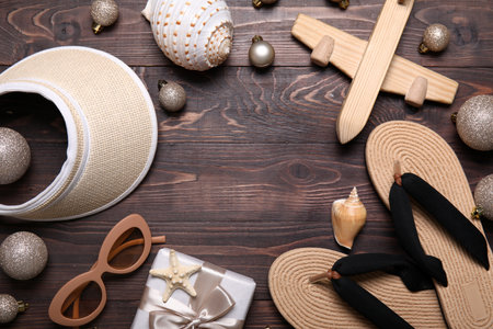 Frame made of travel accessories with Christmas decor on dark wooden backgroundの写真素材