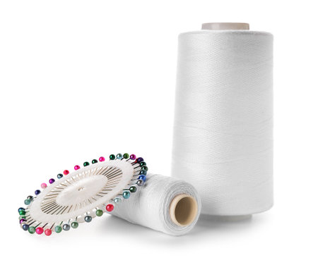 Thread spools and ball pins isolated on white background