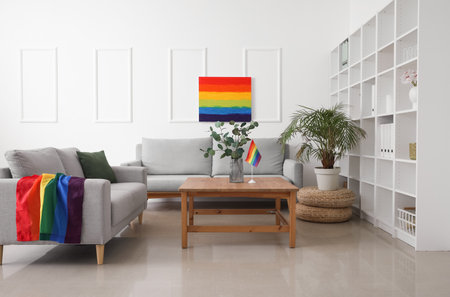Interior of light living room with sofas, LGBT flag and paintingの写真素材