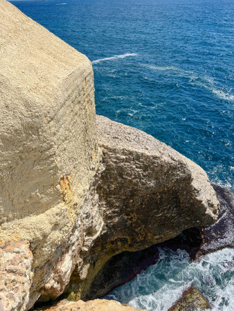 View of high cliff and sea water on sunny dayの写真素材