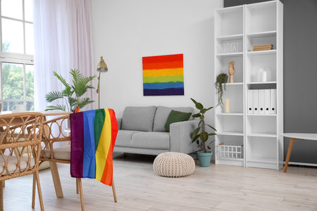 Interior of light dining room with sofa, LGBT flag and paintingの写真素材