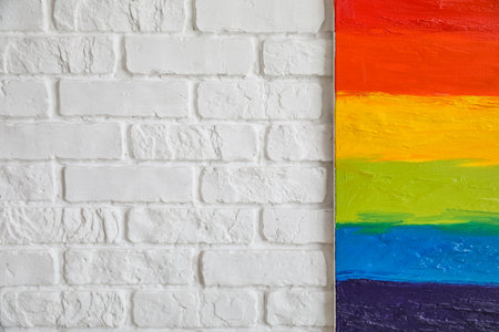 Painting of LGBT flag on white brick wallの写真素材
