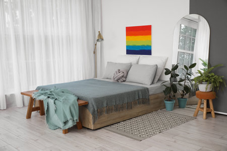 Interior of modern bedroom with rainbow painting and mirrorの写真素材