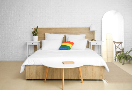 Interior of light bedroom with LGBT pillow and mirrorの写真素材