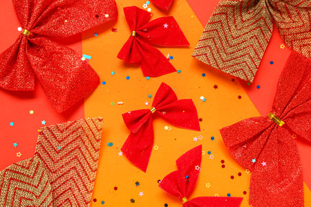 Different Christmas bows and sequins on color backgroundの写真素材