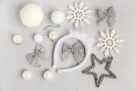 Composition with Christmas headband and decorations on gray background