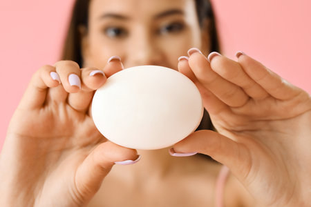 Beautiful young woman with soap on color background, closeup