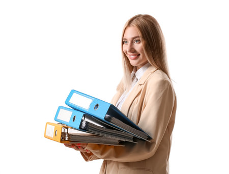Pretty young businesswoman with folders on white backgroundの写真素材