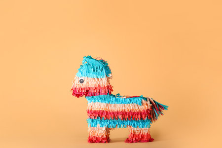 Mexican pinata in shape of horse on color background