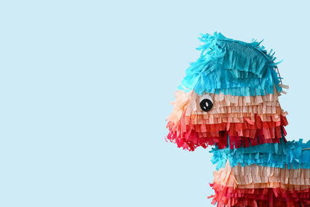 Mexican pinata in shape of horse on color background