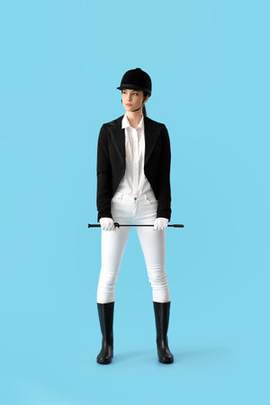 Beautiful female jockey on color backgroundの写真素材