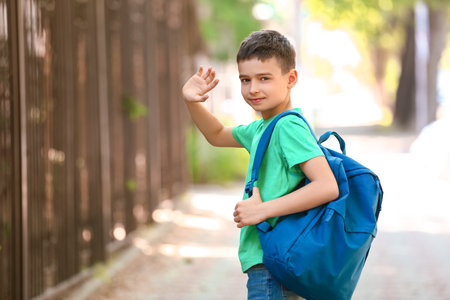 Little schoolboy with backpack outdoorsの写真素材