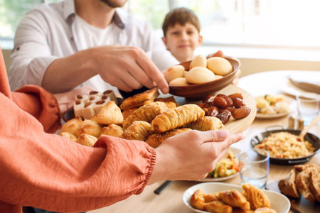 Muslim family having breakfast together. Celebration of Eid al-Fitrの写真素材