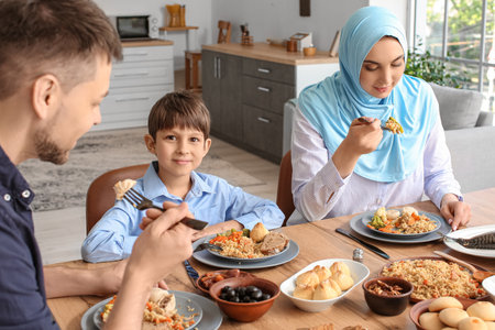 Muslim family having breakfast together. Celebration of Eid al-Fitrの写真素材