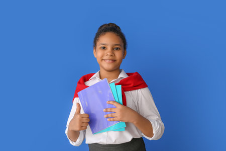 Cute African-American schoolgirl on color background