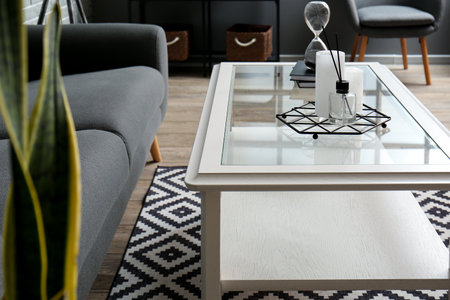 Reed diffuser and candles on table in living room