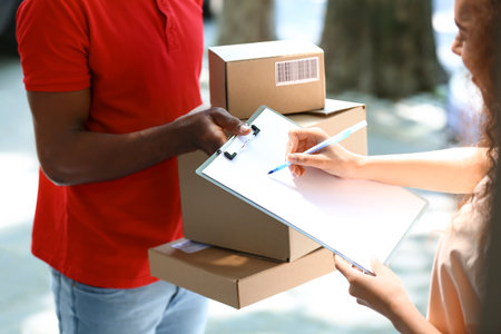 Customer parcel receiving from delivery manの写真素材