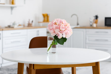 Vase with hydrangea flowers on table in kitchenの写真素材