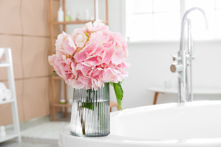 Vase with hydrangea flowers in bathroom, closeupの写真素材