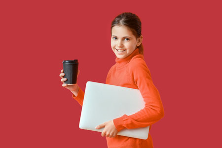 Little programmer with laptop and cup of coffee on color backgroundの写真素材