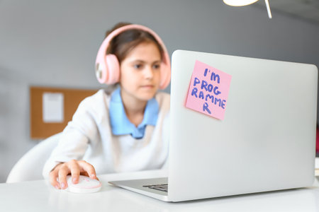 Little programmer working with laptop in office