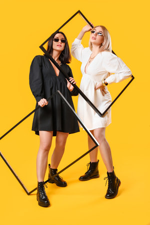 fashionable young women on color backgroundの写真素材