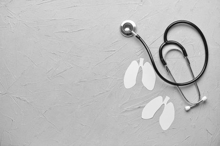 White paper lungs with stethoscope on light backgroundの写真素材