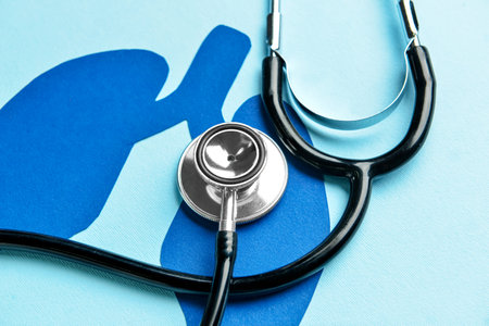 Paper lungs with stethoscope on blue background, closeupの写真素材