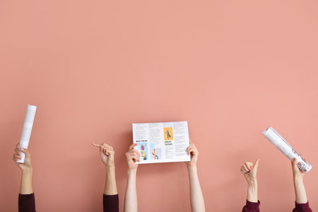 People with newspapers on pink background