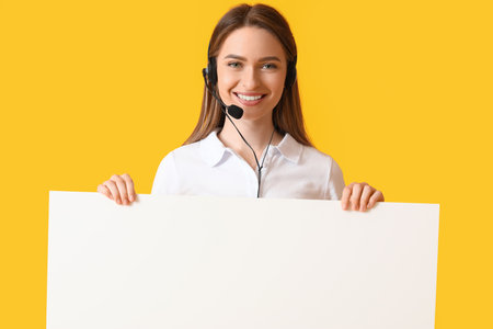 Female technical support agent with blank poster on color backgroundの写真素材