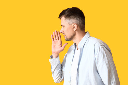 Gossiping man on color backgroundの写真素材