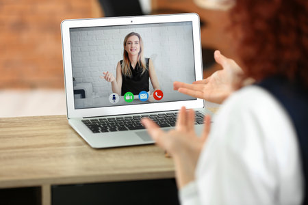 Young woman video chatting with HR manager at home