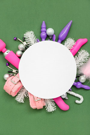 Blank card with sex toys and Christmas decor on green backgroundの写真素材