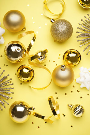 Shiny Christmas decorations on yellow backgroundの写真素材