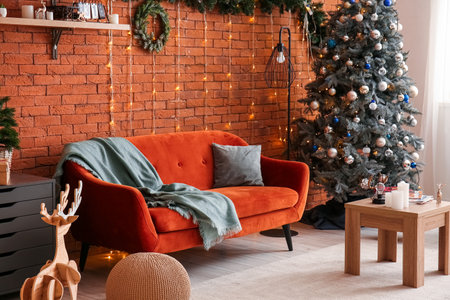 Interior of living room with sofa, Christmas tree and glowing lightsの写真素材