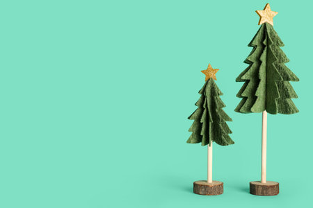 Felt Christmas trees on color backgroundの写真素材