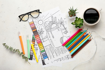 Coloring pages, felt-tip pens, pencils, flowerpots and cup of coffee on white background